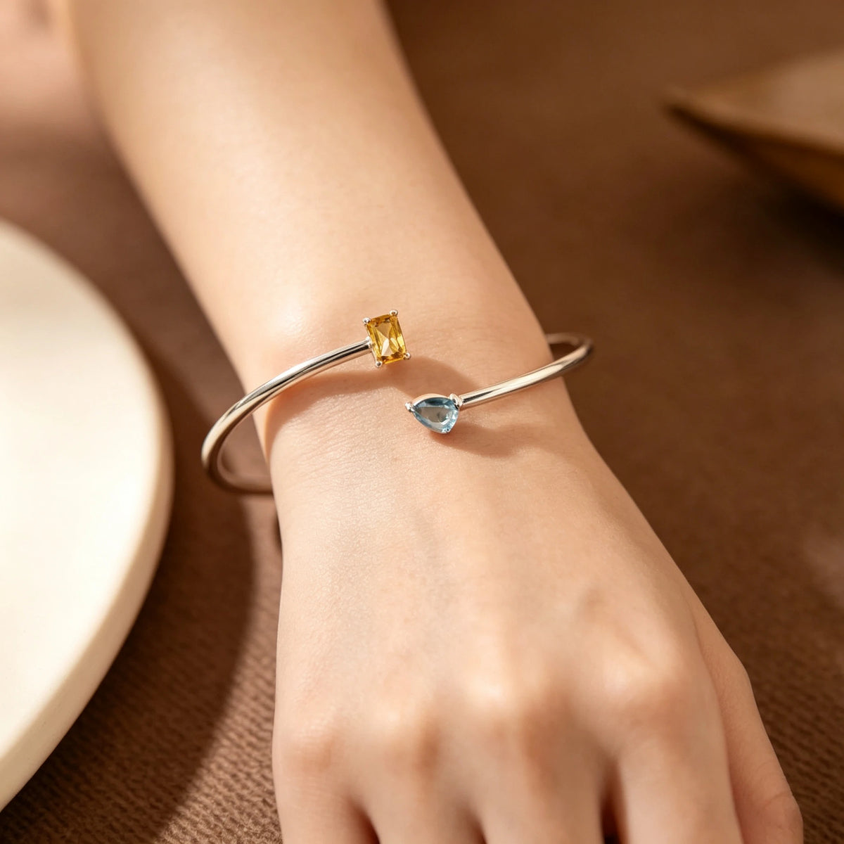 Silver-tone double birthstone bracelet worn on the wrist
