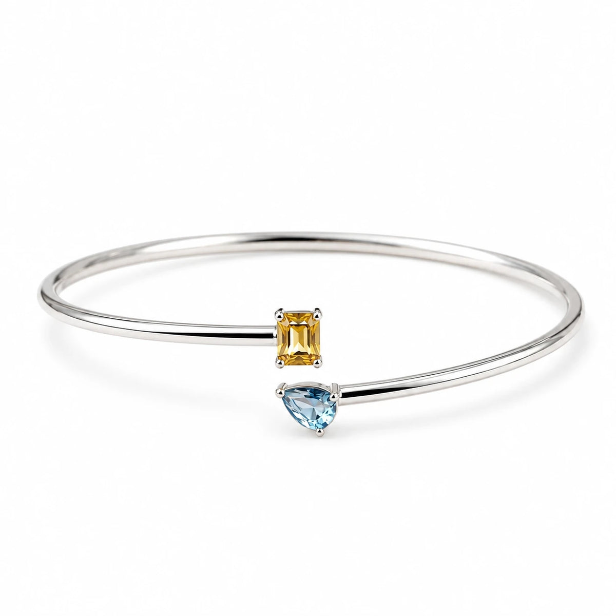 Open silver-tone double birthstone bangle on a white background