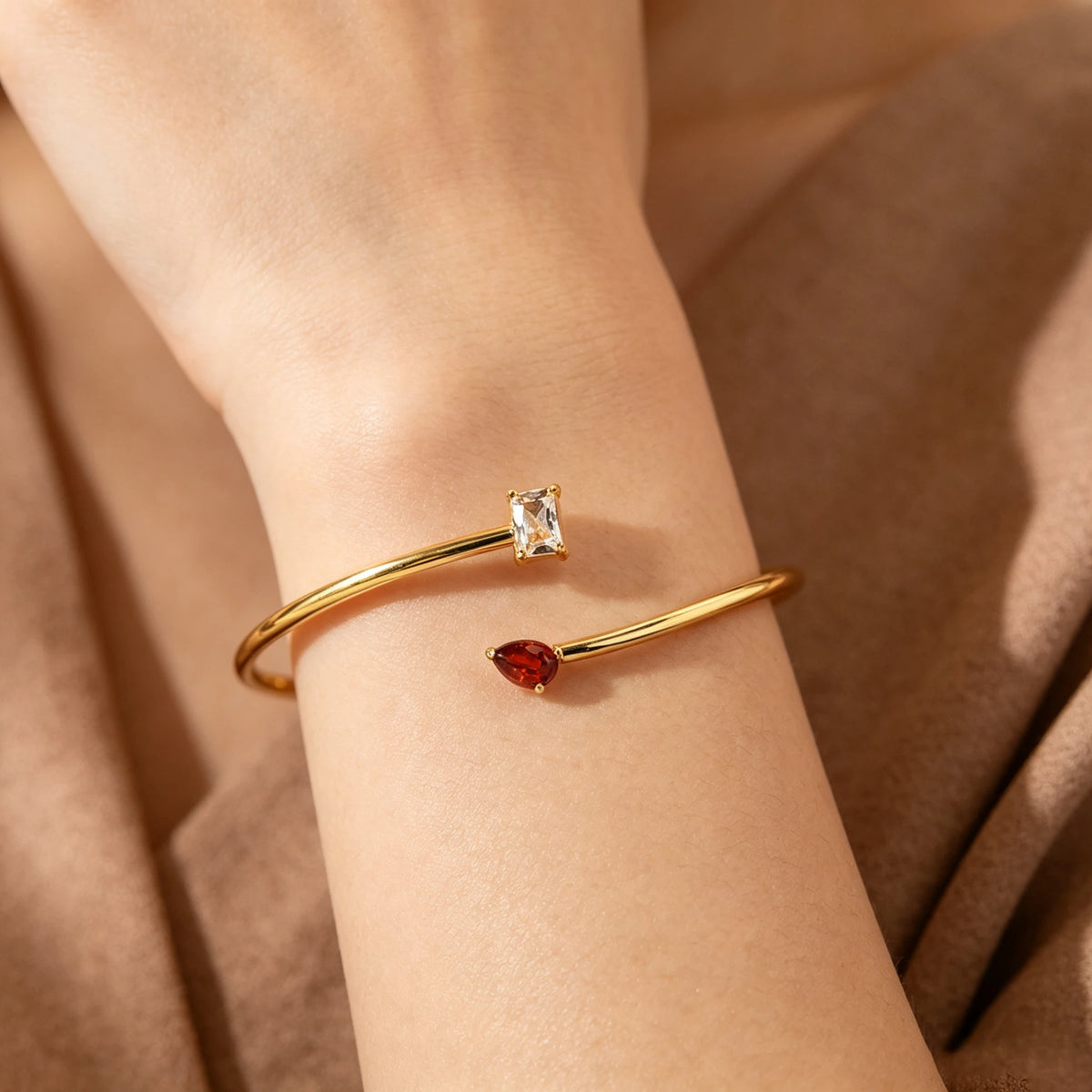Gold-tone double birthstone bracelet worn on the wrist