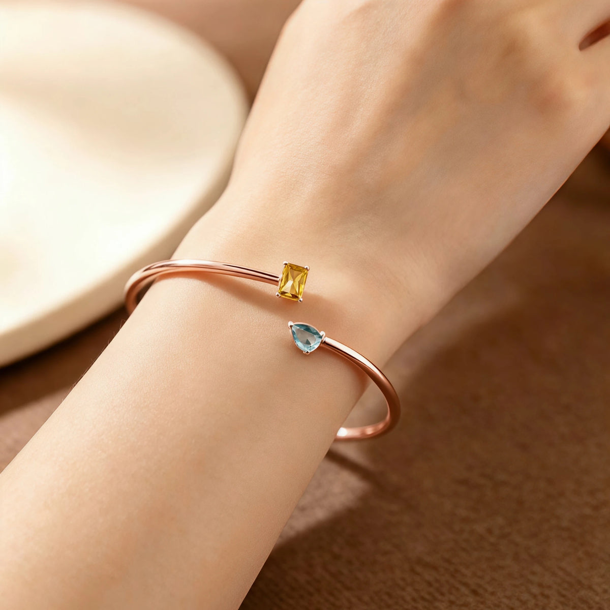 Rose gold-tone double birthstone bracelet worn on the wrist