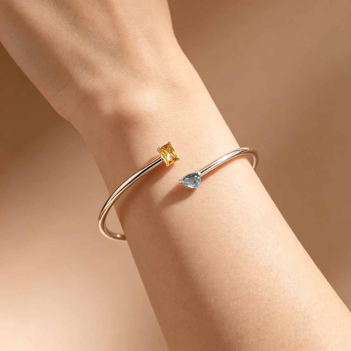 Silver-tone bracelet showing two contrasting birthstone colours