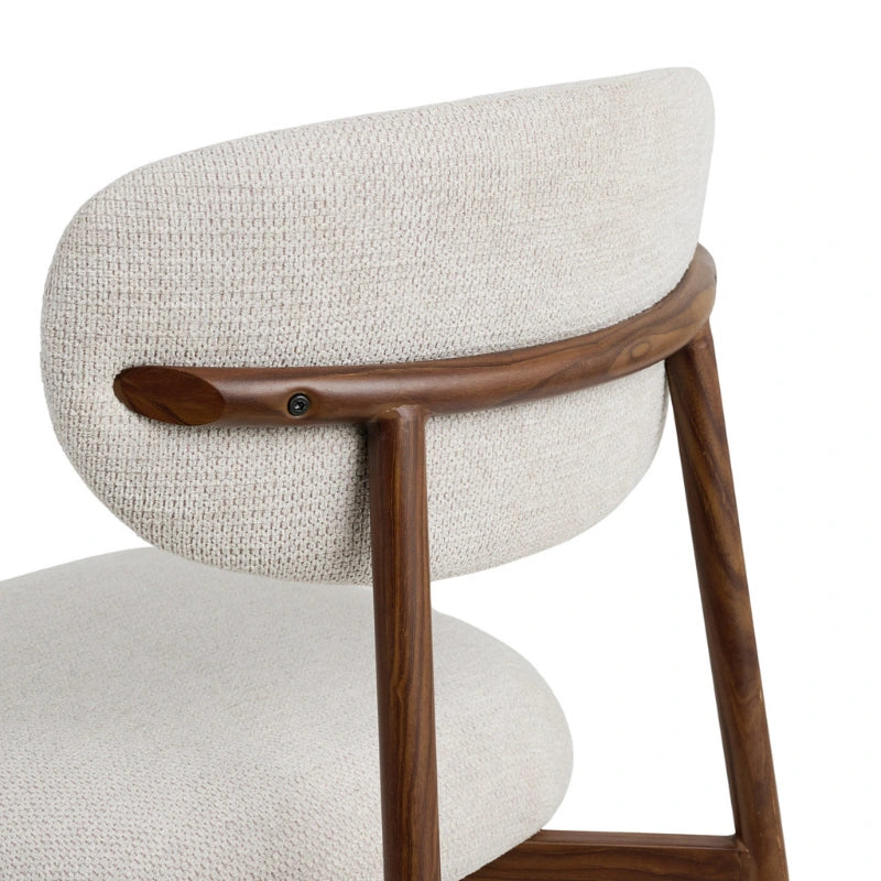 Close-up of the curved upholstered backrest and walnut-brown frame