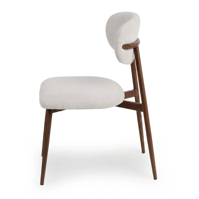 Side detail of the dining chair seat, backrest and wood-effect metal legs