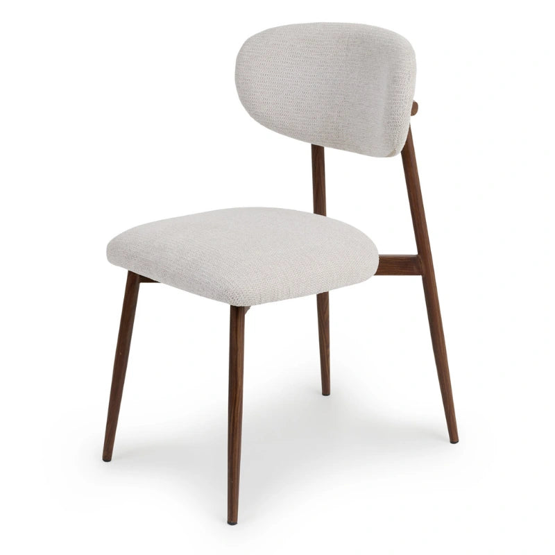 Angled view of a Japandi dining chair with light grey upholstery
