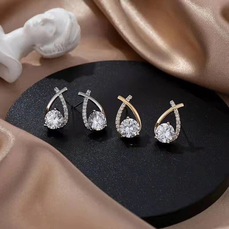 Silver tone and gold tone mermaid tail stud earrings shown together