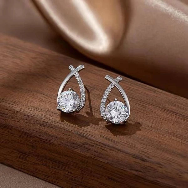 Pair of silver tone mermaid tail stud earrings with round centre stones and curved accents