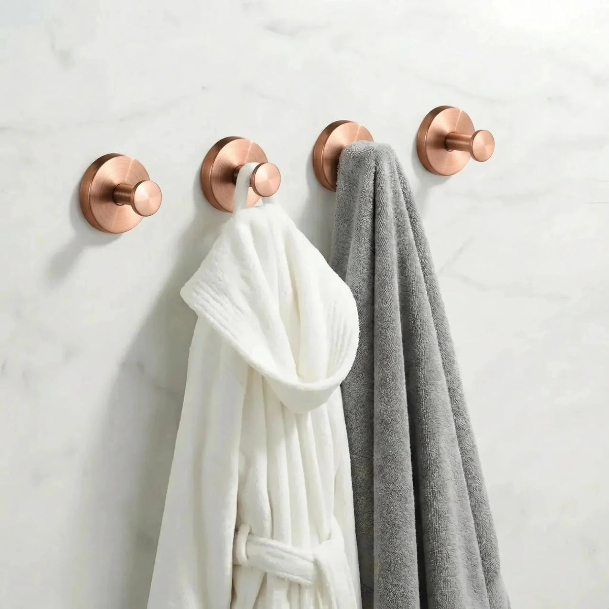 Set of four copper suction cup hooks shown on a bathroom wall