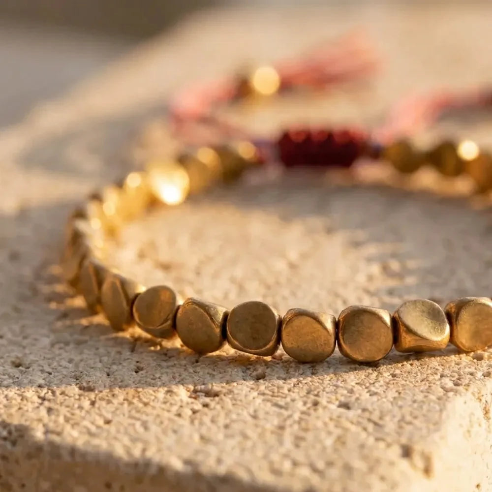 Close-up of softly faceted copper and brass beads