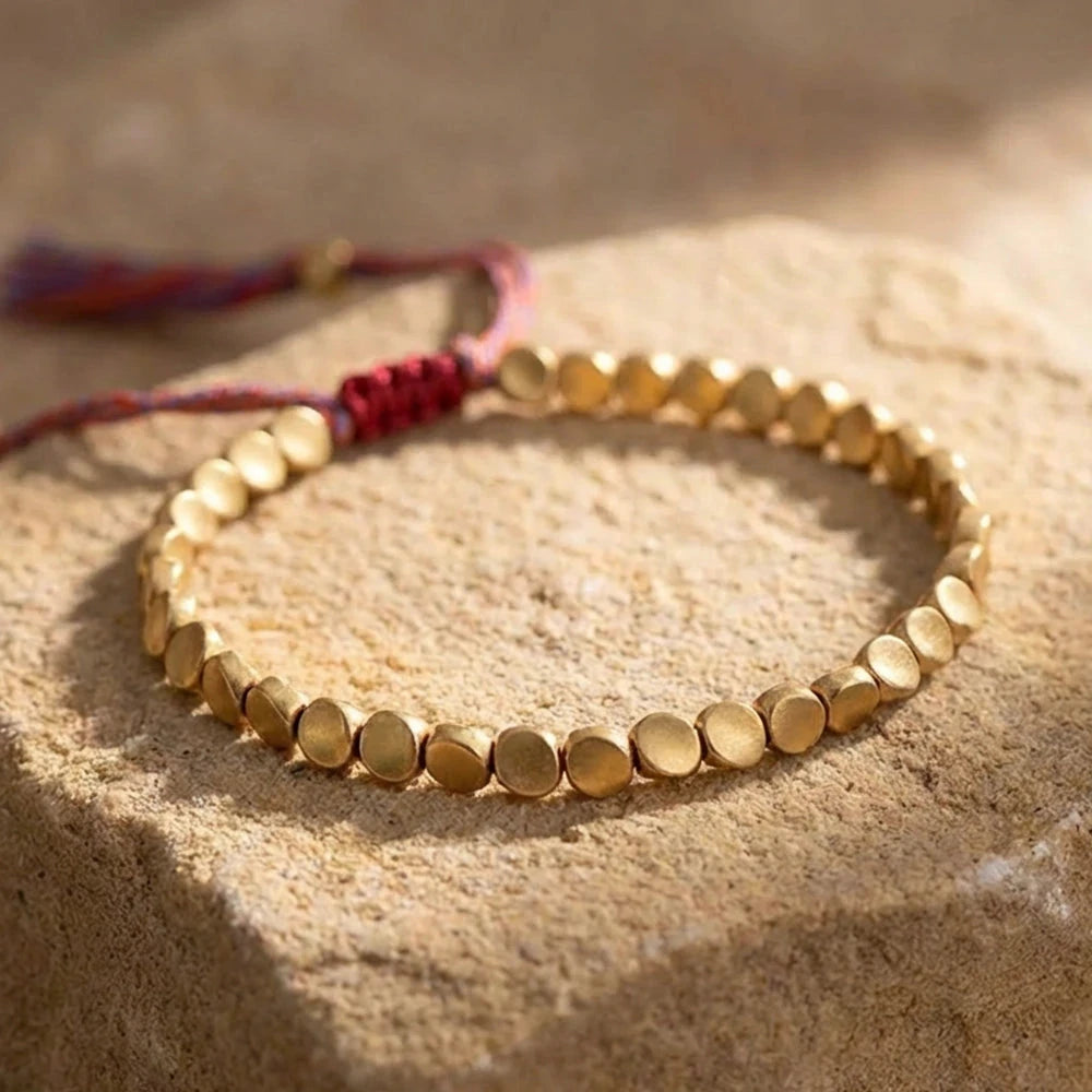 Detail of the red-brown sliding knot and textured metal beads