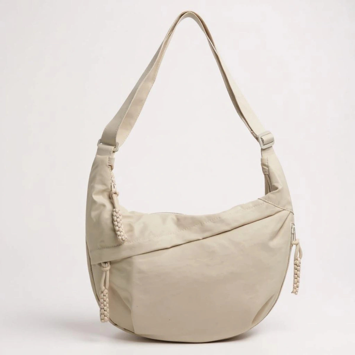 Beige crossbody shoulder bag with zipped pockets and an adjustable strap