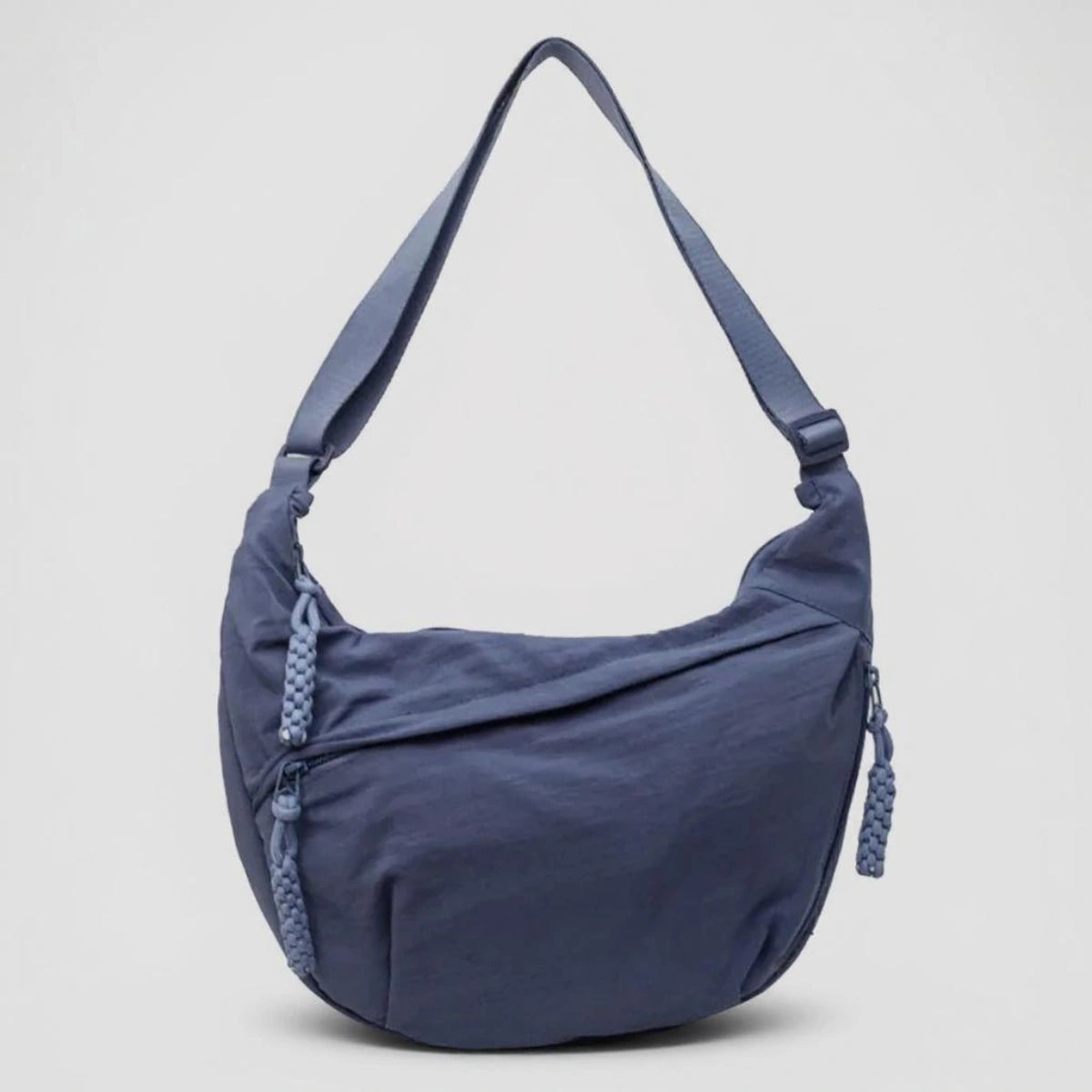 Blue crossbody shoulder bag with zipped pockets and an adjustable strap