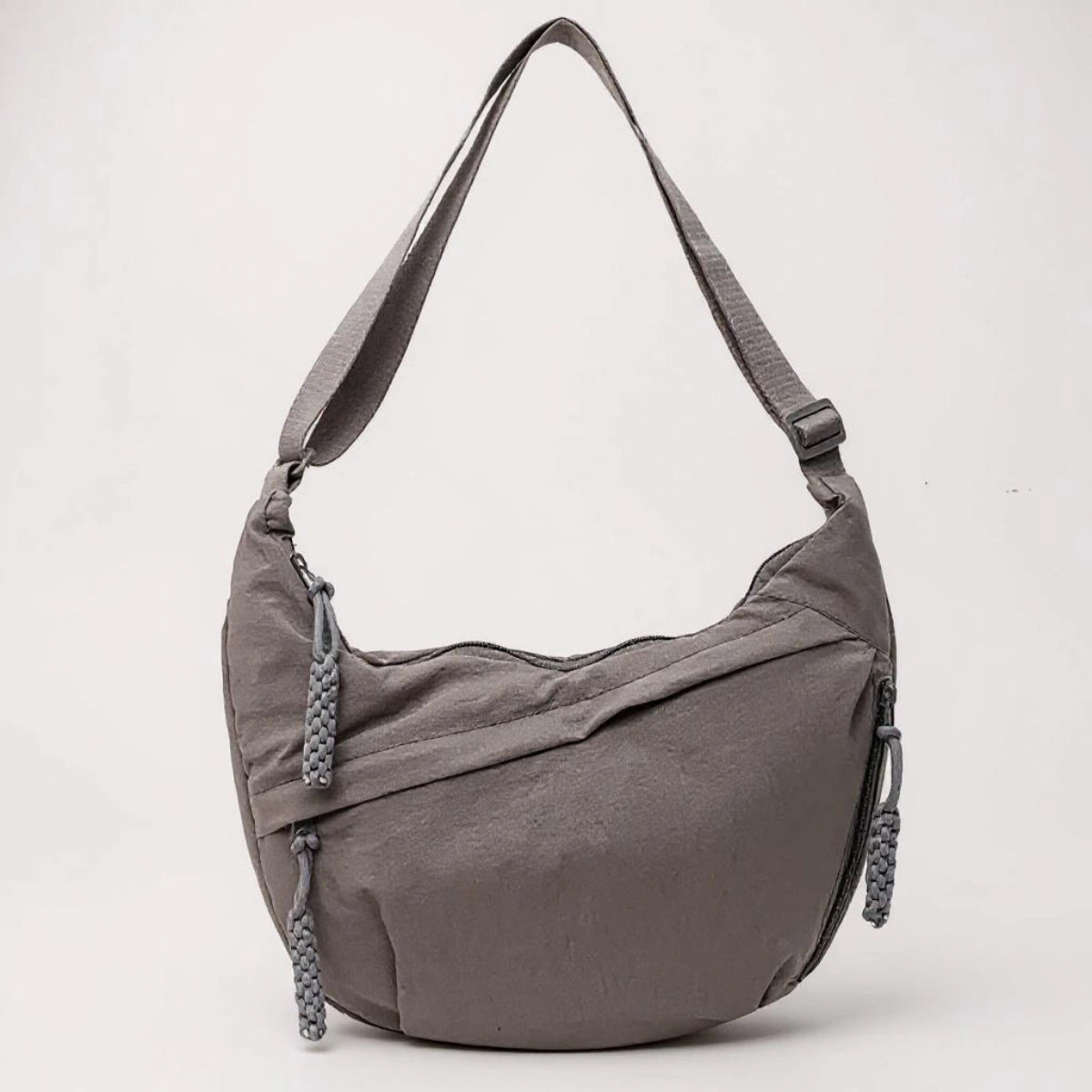 Grey crossbody shoulder bag with zipped pockets and an adjustable strap