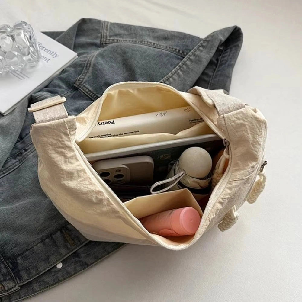 Open beige shoulder bag showing room for a phone and small everyday essentials